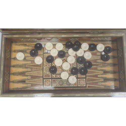 193 - Parquetry inlaid chequerboard games box, hinged with various playing pieces, 51cm wide