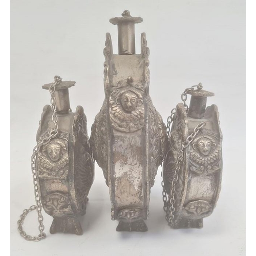 211 - Three silver coloured metal gunpowder flasks, possibly Russian, all relief decorated, two depicting ... 