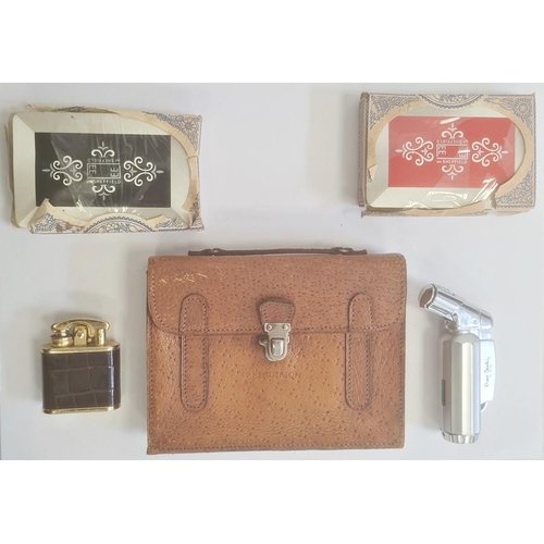 212 - A pigskin card case, enclosing two packs of cards, inscribed 'Henderson', a Pierre Cardin lighter an... 