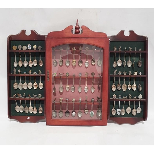 372 - Large quantity of souvenir spoons in two display shelves and a display case and various loose spoons