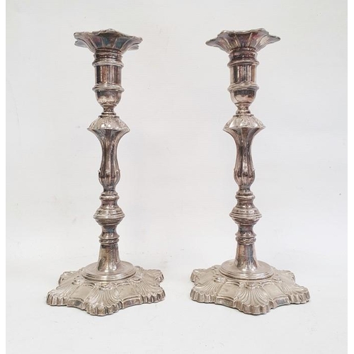 380 - Pair of 1970's silver-mounted candlesticks with relief decoration, on quatrefoil-shaped bases and sc... 