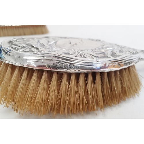 454 - An Edward VII silver mounted dressing brush, floral decorated, Birmingham 1905, a silver mounted bru... 