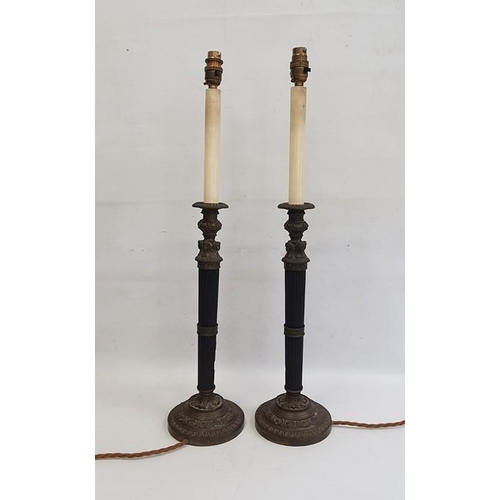 102 - Pair of table lamps with fluted black composite stems and bronze-effect mounts, decorated with femal... 