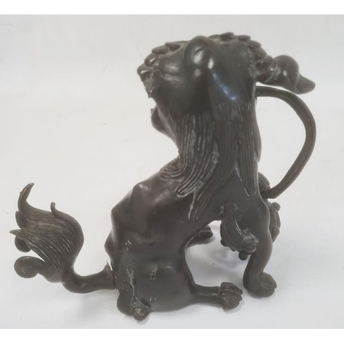 93 - Chinese bronze model of a lion dog seated with pierced ball (with losses), 20cm high