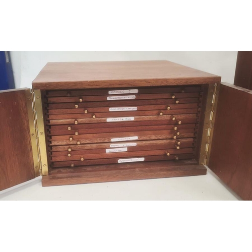 1072 - Two coin collector's cabinets each with a pair of doors enclosing assorted coin drawers (2)