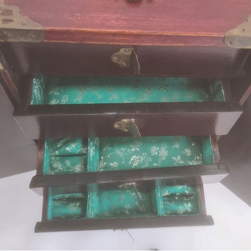 130 - Two Chinese table cabinets, the wooden bodies with brass mounts, the hinged doors and drawer with ca... 