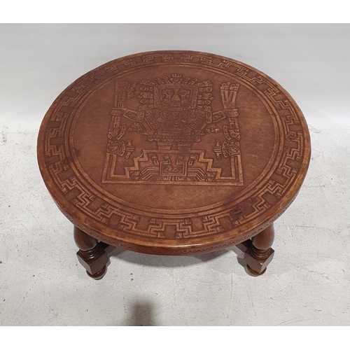 1354 - Circular coffee table with brown leather top with aztec design, on turned and block supports, stretc... 