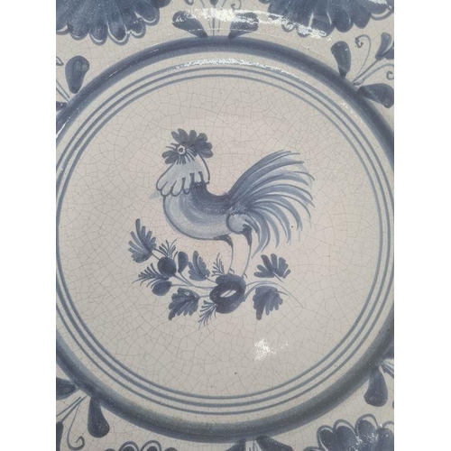 18 - Four modern Spanish blue and white dishes decorated with birds, fish and flowers, within stylised bo... 