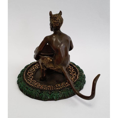 216 - Bronze model of a faun holding a large vase, on a circular base, gilt and green painted, with label ... 