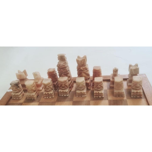 252 - Modern carved stone chess set on wooden board, 40cm wide