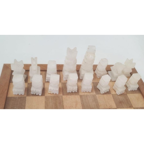 252 - Modern carved stone chess set on wooden board, 40cm wide