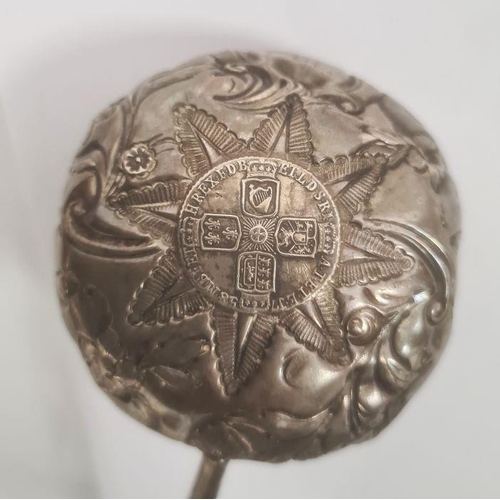 357 - Silver-coloured mounted ladle inset with George II coin and repousse decorated, with turned handle