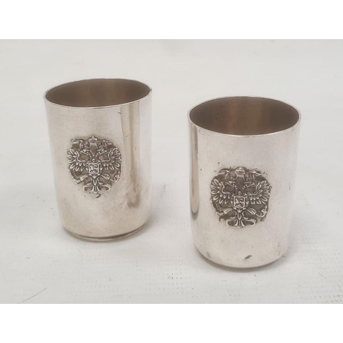 398 - Pair of mid to late 19th century Russian silver shot glasses with relief crest and engraved detail, ... 