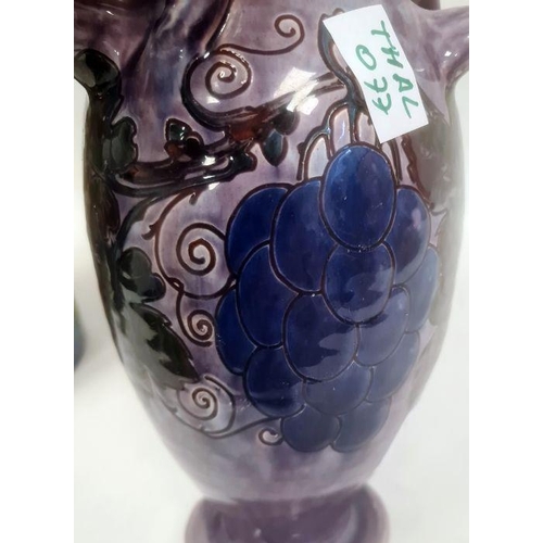 46 - Torquay pottery vase decorated with a bird perched on fruiting branches, 32cm high (large chip to ba... 