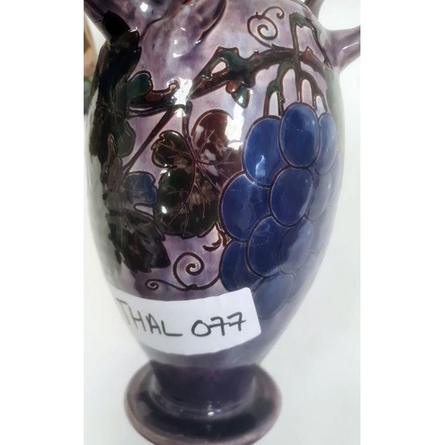 46 - Torquay pottery vase decorated with a bird perched on fruiting branches, 32cm high (large chip to ba... 