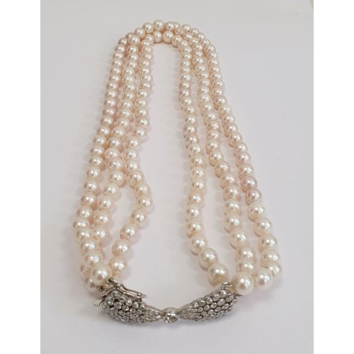 469 - Diamond and pearl triple strand necklace having diamond set bow-shaped clasp with collet set stone a... 