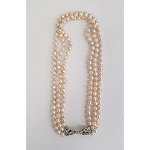 469 - Diamond and pearl triple strand necklace having diamond set bow-shaped clasp with collet set stone a... 