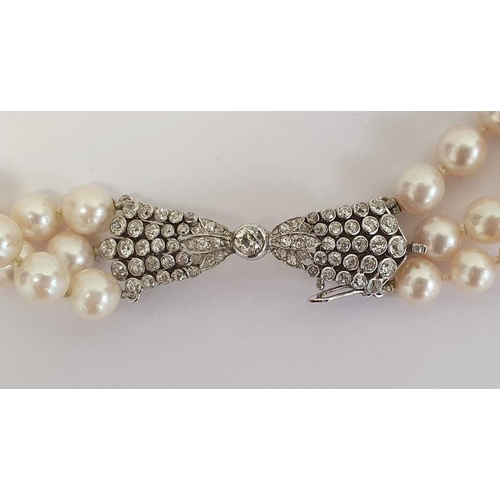 469 - Diamond and pearl triple strand necklace having diamond set bow-shaped clasp with collet set stone a... 