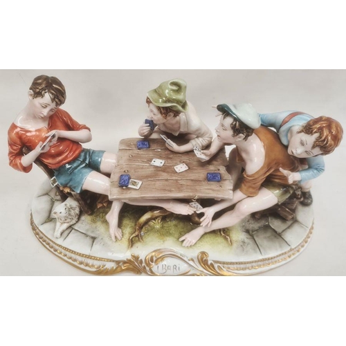 48 - Ciche porcelain figural group of boys seated at a table playing cards, the oval base with gilt borde... 