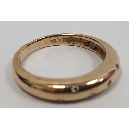 490 - Gold ring set with seven small diamonds in rubover setting, marked 585, finger size P1/2, approx. we... 