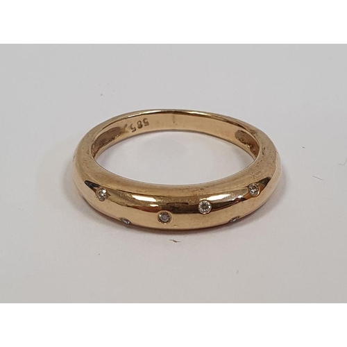 490 - Gold ring set with seven small diamonds in rubover setting, marked 585, finger size P1/2, approx. we... 