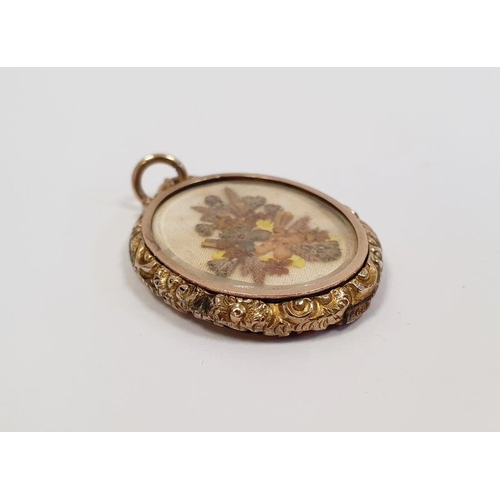 504 - 9ct gold double glass locket, oval with scroll surmount, chased sides inset with small pressed flowe... 