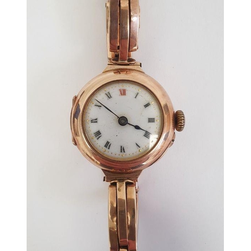 594 - A lady's 9ct gold wristwatch, Roman numerals to the white enamel dial, in a Penlington & Batty fitte... 