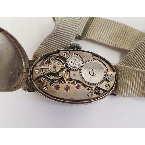 607 - A 1920s platinum and diamond lady's wristwatch on fabric strap, oval with Arabic numerals and an ova... 