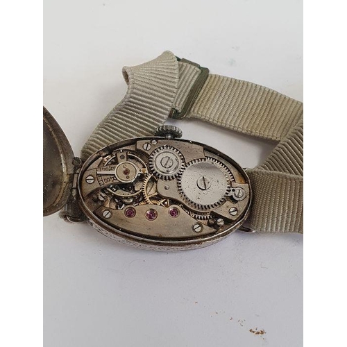 607 - A 1920s platinum and diamond lady's wristwatch on fabric strap, oval with Arabic numerals and an ova... 