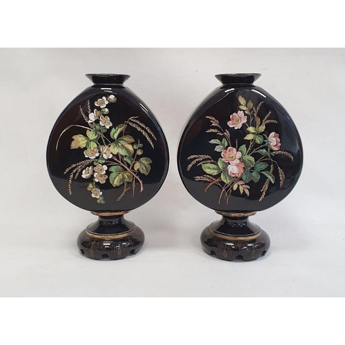 83 - Pair of Victorian opaque black glass vases of shaped moonflask design, on circular pedestal bases, e... 