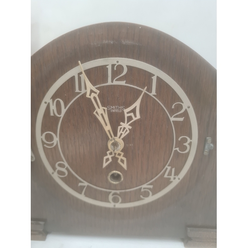 1053A - Smiths mantel clock in oak case and another mantel clock in oak case, with turned pilasters and arch... 