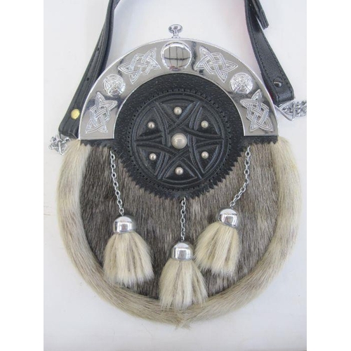 112 - Two Nicol Bros Bankfoot leather, fur and metal sporrans, another without belt in leather with tassel... 