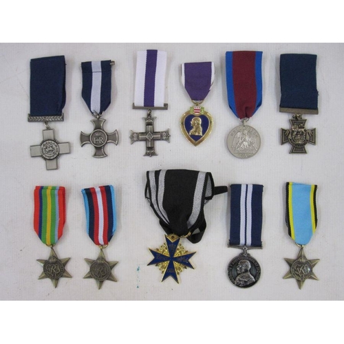 14 - Eleven copies / reproduction metals to include Victoria Cross and Military Cross enclosed in glazed ... 