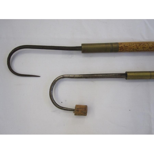 70 - Two fishing gaffs with long brass and wooden handles, one stamped Hardy bros Makers, Alwick, the oth... 