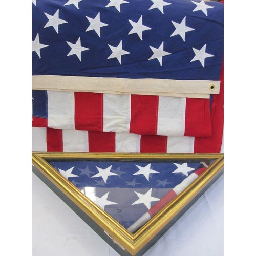 86 - Two full-sized United States of America stars and stripes flags, one being enclosed in a glazed case... 