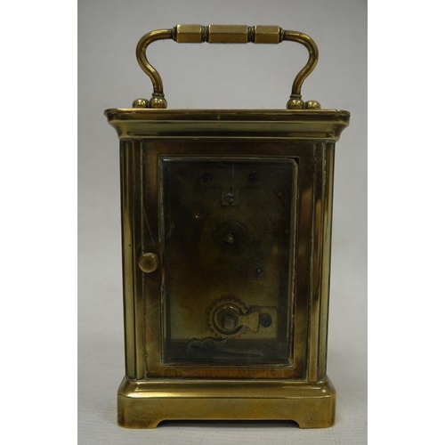 1063 - Brass and glass-cased carriage clock with handle