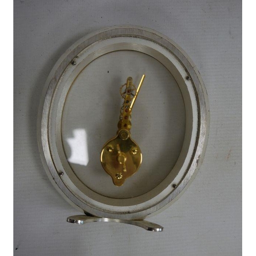 1084 - Jaeger Le Coultre mantel clock, the oval glass dial marked 'Jaeger Le Coultre', 16-jewels