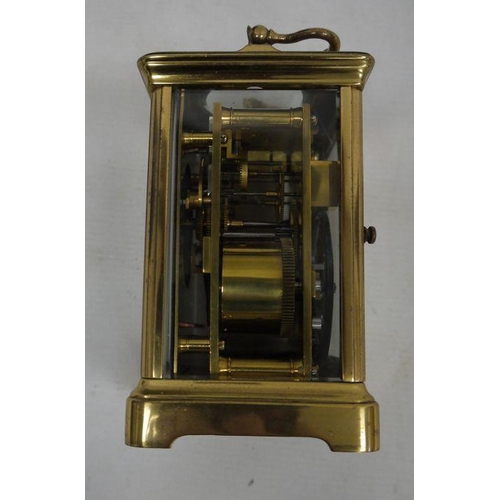 1085 - Brass and glass carriage clock with Roman numerals to the dial, in leather carry case