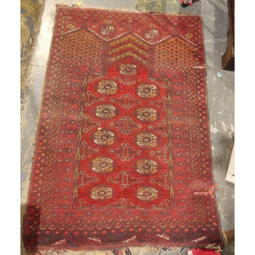 1089 - Red ground Eastern rug with five elephant's foot guls to the central field, stepped border, 110cm x ... 