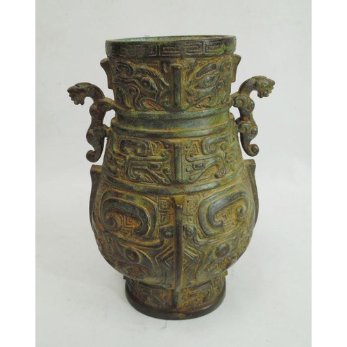 118 - Cast bronze baluster vase-patterned table lamp, two-handled and on carved hardwood scroll base, fitt... 