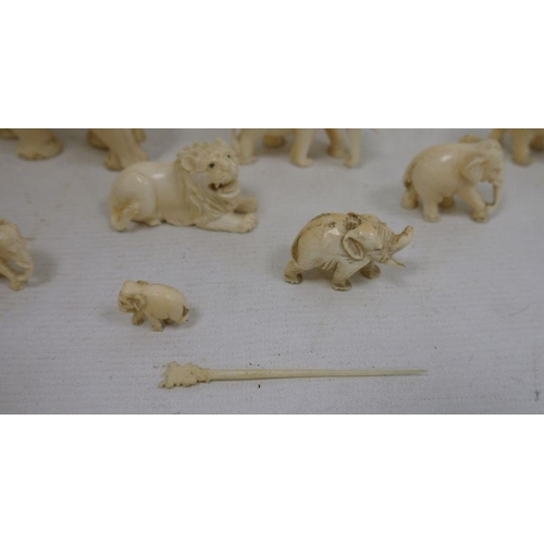 123 - Collection of carved ivory elephants, lions, etc, graduated, largest 8.5cm high (1 box)