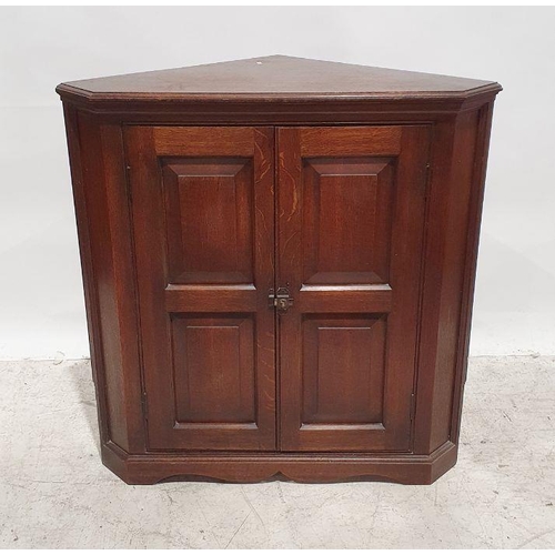 1300 - Oak corner cupboard with two panelled doors, the whole on bracket feet, 92cm high