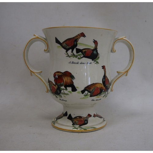 19 - Ceramic two-handled trophy cup decorated with fighting birds 'A Challenge', 'A Knock Down Blow', etc... 