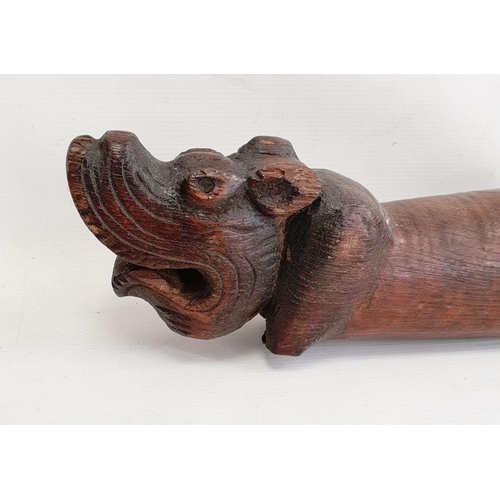 208 - Carved hardwood boat tiller, probably 18th century, the long wooden tiller carved with a griffin mas... 