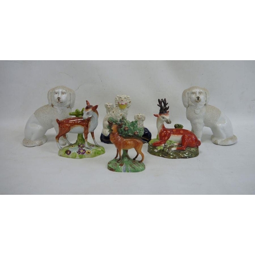 35 - Staffordshire pottery deer, another stag, a spaniel group, a stag with bocage and a pair of china sp... 