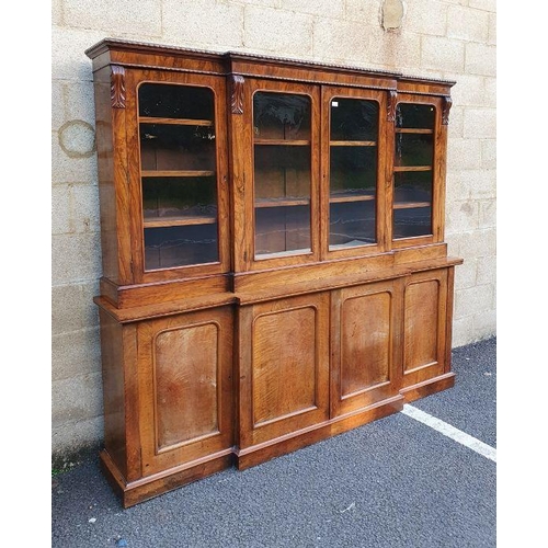 1135 - Victorian rosewood breakfront bookcase, frieze carved with beaded decoration over four glazed doors,... 