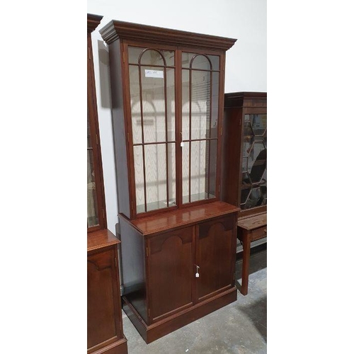 1148 - Pair of 20th century mahogany cabinets, the moulded cornices above astragal-glazed doors enclosing s... 