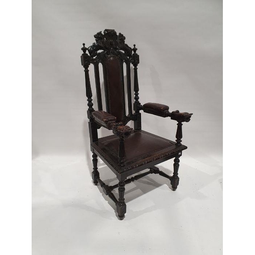 1322 - Late 19th/early 20th century armchair, the top rail carved with lions bearing shield, leather uphols... 