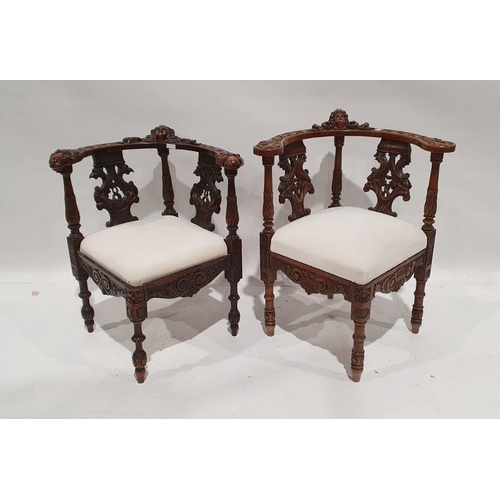 1352 - Two similar corner armchairs with heavily carved top rails featuring mask decoration, carved and pie... 