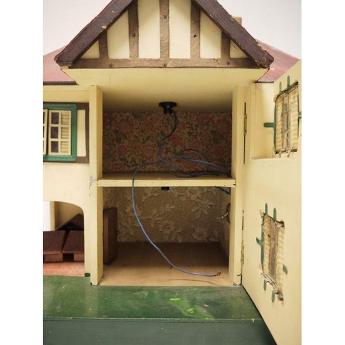 436 - A Triang painted doll's house, 42cm high with wooden painted clock tower (2)